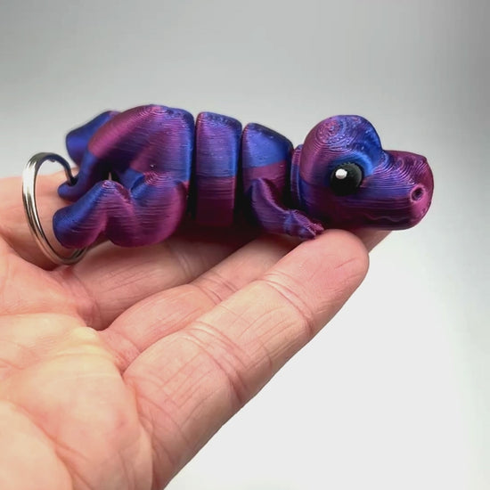 3D Printed Articulated Cute Tyrannosaurus Rex Chunky Keychain in Red+Blue Shifting Flexi Collector Item Showing Articulation and Flexibility