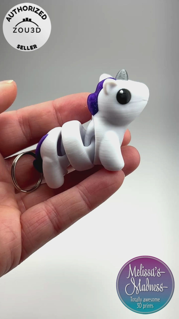 3D Printed Articulated Cute Unicorn Chunky Keychain in White, Witch's Brew, & Silver Flexi Collector Item Showing Articulation and Flexibility