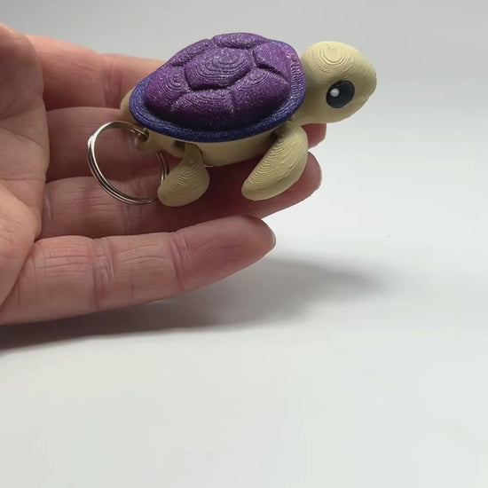 Handcrafted Cute Turtle Chunky Keychain in Desert & Glittering Galaxy Articulated Figurine Made in Montana Demonstrating Joint Flexibility