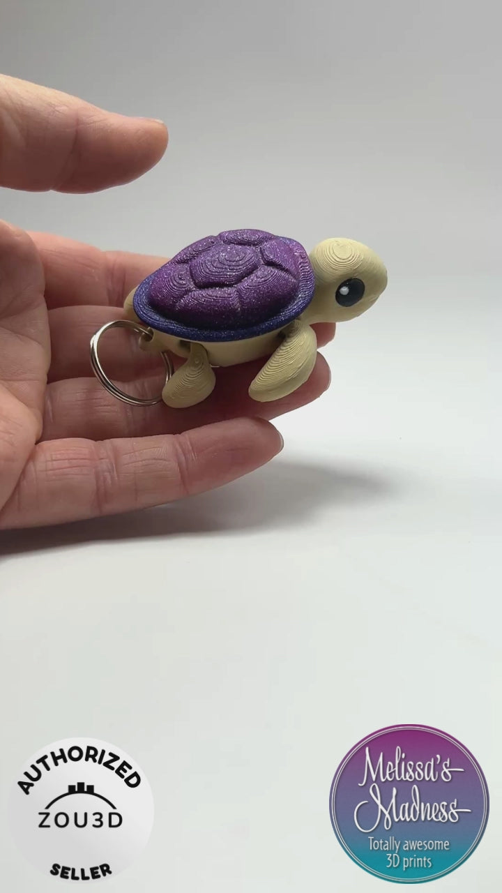 Handcrafted Cute Turtle Chunky Keychain in Desert & Glittering Galaxy Articulated Figurine Made in Montana Demonstrating Joint Flexibility